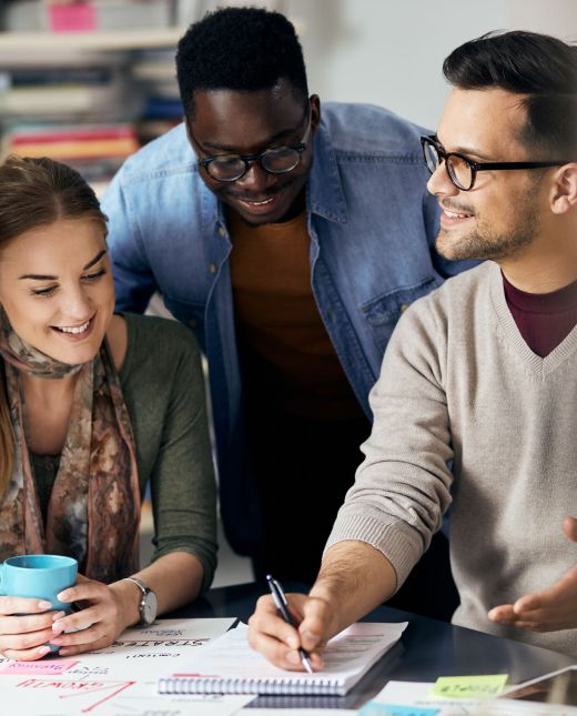 Happy creative team writes business ideas while brainstorming during meeting office. Happy creative team writes business ideas while brainstorming during meeting office.